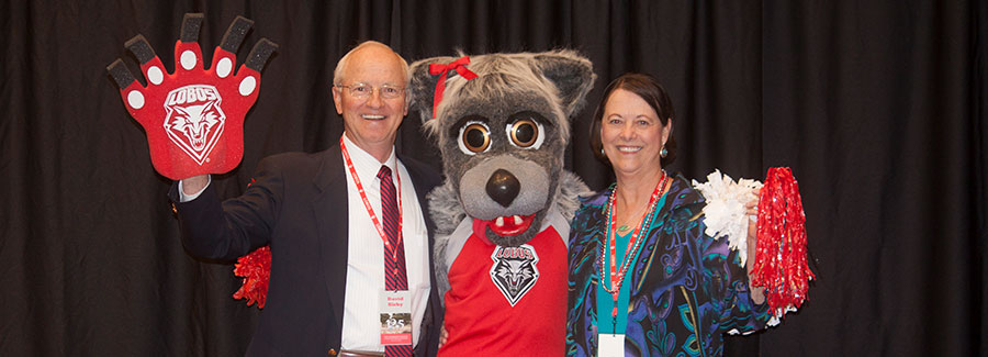 Photo of alumni with the school mascot